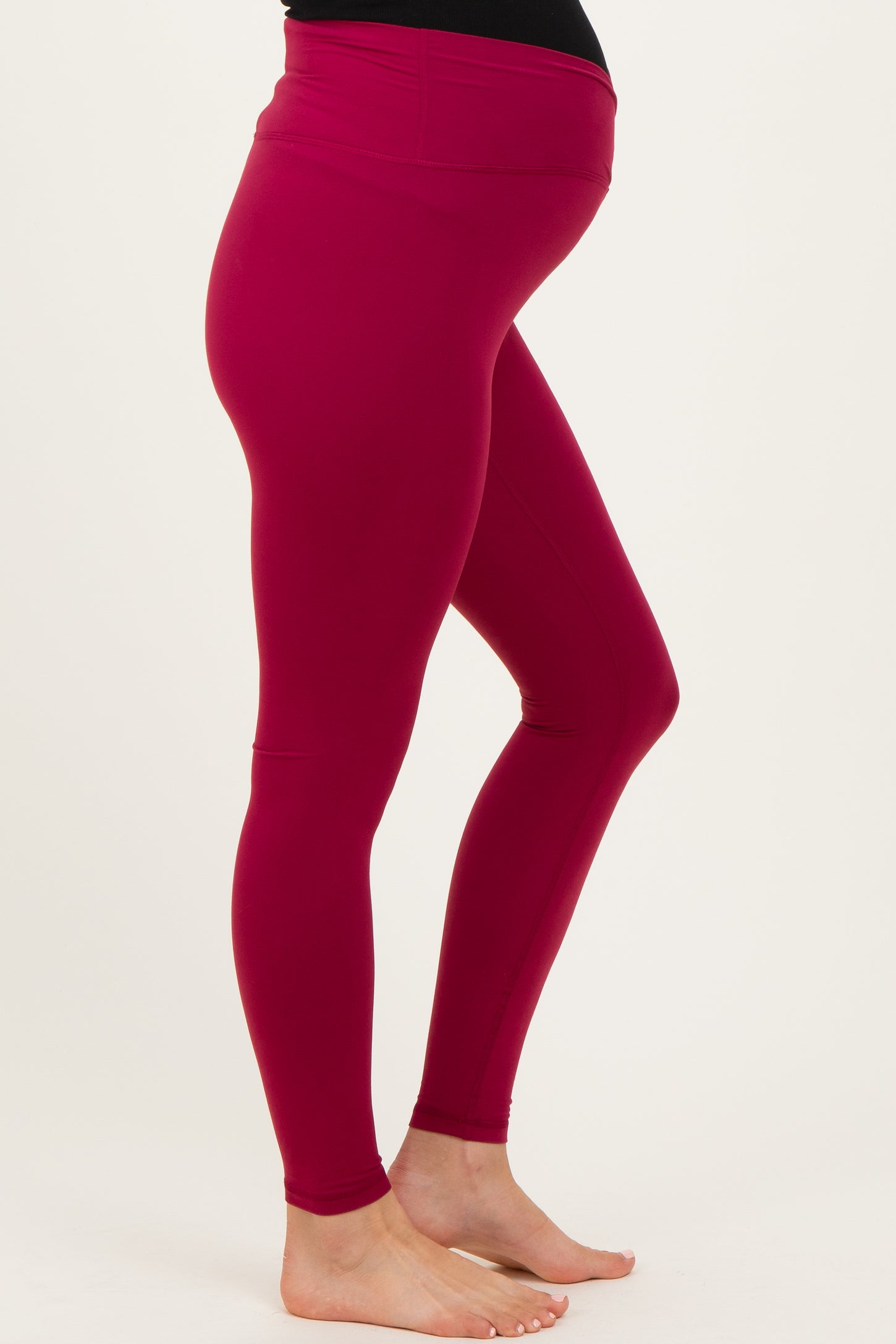 maternity wear burgundy leggings with a high waistband designed for comfort and support, showcasing a baby bump