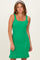 woman wearing a vibrant green ribbed knit dress with a fitted silhouette and ruffle hem