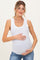 woman wearing a white ribbed maternity tank top and holding her baby bump