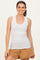woman wearing a light gray ribbed tank top and tan shorts