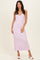 woman wearing a light purple ribbed midi dress with spaghetti straps and a fitted silhouette