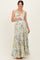 woman wearing a floral print maternity maxi dress with a fitted bodice and pleated skirt, showing her baby bump