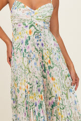 woman wearing a floral print pleated maxi dress with a sweetheart neckline and spaghetti straps