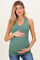 woman wearing a green ribbed maternity tank top and holding her baby bump