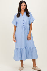 woman wearing a blue and white striped button-up midi dress with short sleeves and a tiered ruffle hem