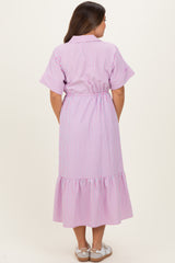 woman wearing a pink and white striped maternity dress with short sleeves and a ruffled hem