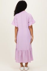 woman wearing a lilac and white striped midi dress with short sleeves and a ruffled hem