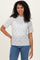woman wearing a white floral short sleeve top with a scalloped neckline and smiling