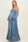 woman wearing a blue lace maternity gown with off-the-shoulder sleeves and a visible baby bump