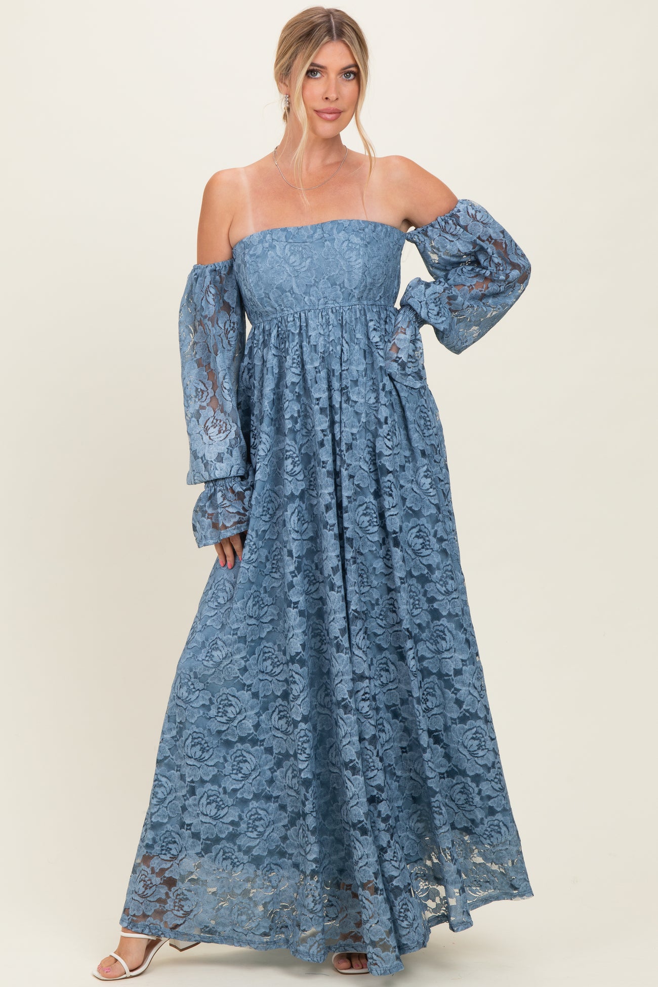 woman wearing a powder blue off-the-shoulder lace maxi dress with long balloon sleeves