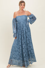 woman wearing a powder blue off-the-shoulder lace maxi dress with long balloon sleeves