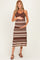 woman wearing a brown striped maternity dress and holding her baby bump