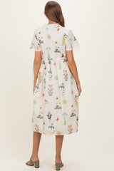 woman wearing a floral print maternity dress with short sleeves and a tiered skirt, showcasing a baby bump