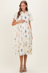 woman wearing a short sleeve floral print maternity dress and holding her baby bump