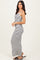 woman wearing a white and black striped maxi dress with spaghetti straps