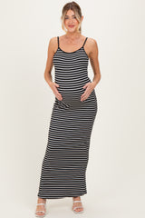 woman wearing a black and white striped maternity maxi dress and holding her baby bump