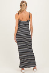 woman wearing a black and white striped maternity maxi dress with spaghetti straps, showing her back