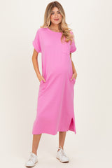 woman wearing a hot pink maternity t-shirt dress with short sleeves and pockets, showcasing her baby bump