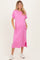 woman wearing a hot pink maternity t-shirt dress with short sleeves and pockets, showcasing her baby bump