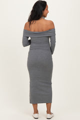 woman wearing a gray off-the-shoulder maternity dress, showing a form-fitting style and long sleeves