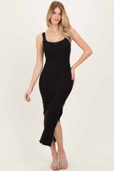 woman wearing a black sleeveless midi dress with lace trim and a side slit