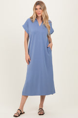 woman wearing a light blue short sleeve maxi dress with a V-neck and pockets