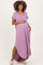 woman wearing a lavender short sleeve maternity dress with a v-neck and pockets, showing her baby bump