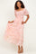 woman wearing a pink floral maxi dress with smocked bodice and puff sleeves