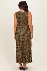 woman wearing a floral maternity maxi dress with tiered detailing, showing the back view