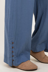 maternity wear in light blue wide-leg pants with button detail at the hem, styled with beige footwear