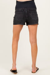 woman wearing black maternity shorts, showing the back view with a stretchy waistband