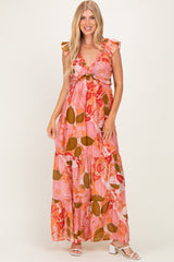 woman wearing a pink floral maxi dress with ruffle sleeves and a gathered waistline