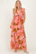 woman wearing a pink floral maxi dress with ruffle sleeves and a gathered waistline