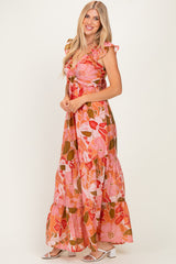 woman wearing a pink floral maxi dress with ruffle sleeves and a tiered skirt