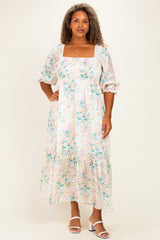 woman wearing a floral plus size maxi dress with puff sleeves and a square neckline
