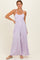 woman wearing a lavender sleeveless jumpsuit with wide legs and side pockets