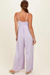 woman wearing a light purple sleeveless jumpsuit with a flowy wide leg design, shown from the back