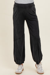 woman wearing black maternity jogger pants with a relaxed fit and ankle cuffs