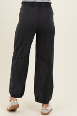 maternity wear black wide-leg pants with an elastic waistband and pleat detailing, modeled from the back