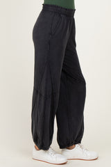 woman wearing black slouchy sweatpants with a relaxed fit and elastic waistband