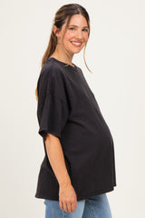 woman wearing a black oversized maternity t-shirt with short sleeves and a visible baby bump