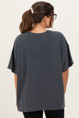 woman wearing a dark gray oversized maternity top with short sleeves, viewed from the back