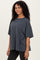 woman wearing a dark gray oversized t-shirt with a relaxed fit and short sleeves