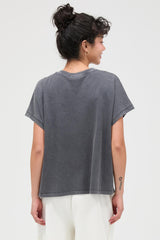 woman wearing a relaxed fit gray oversized t-shirt with short sleeves and a round neckline