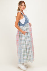 woman wearing a denim and plaid maternity maxi dress with a baby bump, featuring adjustable straps and pockets