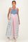 woman wearing a denim maternity dress with a colorful plaid skirt and pockets, styled for a relaxed fit
