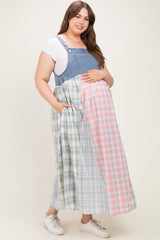 woman wearing a denim and plaid maternity dress with pockets and a visible baby bump