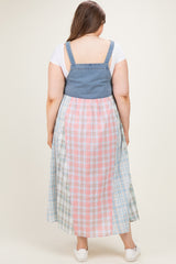 woman wearing a denim and plaid maxi dress from the back, showing a mix of pastel colors and a flowing fit, maternity wear