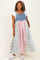 woman wearing a denim and plaid maxi dress with a fitted bodice and flowy skirt, styled casually with white sneakers