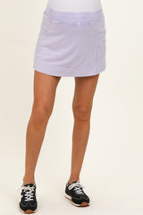 maternity wear lavender sporty skirt with elastic waistband, model wearing it with black athletic shoes